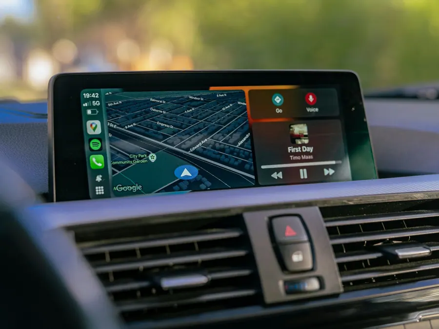 Dash-mounted touchscreen running Apple CarPlay with maps and music on screen